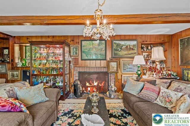 1341 Beaver Valley Rd, Hamilton Twp, PA 18360 - living room with wooden walls, beam ceiling, a chandelier, and a fireplace