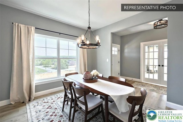 2010 Settlers Ridge Rd Lot 4, North Whitehall Twp, PA 18080 - dining area featuring wood finished floors, healthy amount of natural light, a chandelier, and french doors