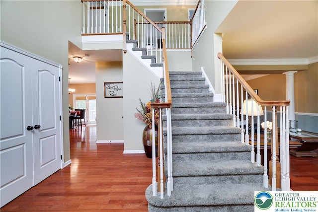 638 Stratton Dr, Middle Smithfield Twp, PA 18302 - stairway with wood finished floors, ornate columns, and a towering ceiling