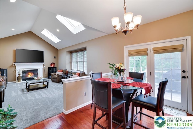 638 Stratton Dr, Middle Smithfield Twp, PA 18302 - dining area with hardwood / wood-style flooring, lofted ceiling, a skylight, plenty of natural light, and a glass covered fireplace