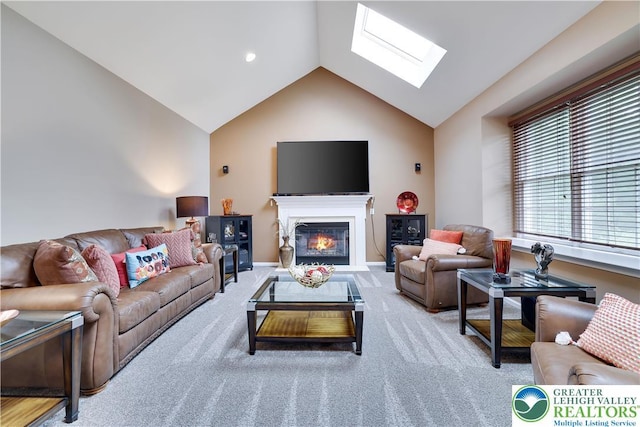 638 Stratton Dr, Middle Smithfield Twp, PA 18302 - living room with a skylight, vaulted ceiling, carpet floors, and a glass covered fireplace
