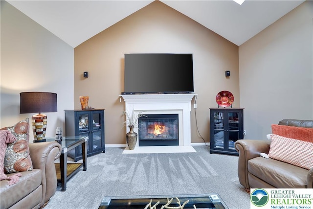 638 Stratton Dr, Middle Smithfield Twp, PA 18302 - living room featuring vaulted ceiling, carpet flooring, and a fireplace with flush hearth