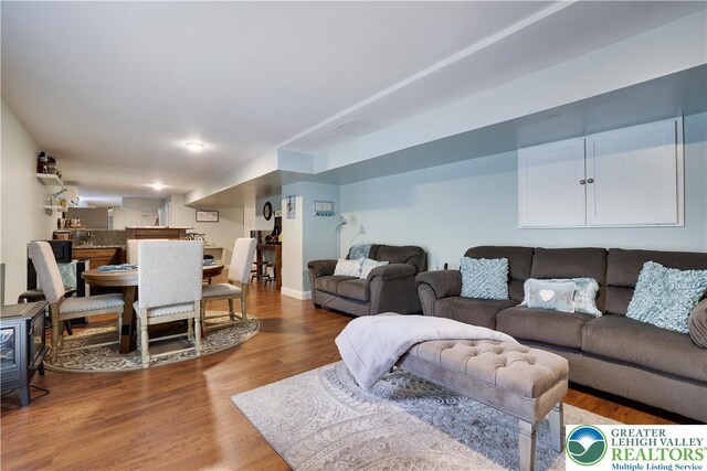 638 Stratton Dr, Middle Smithfield Twp, PA 18302 - living room featuring wood finished floors and a wood stove