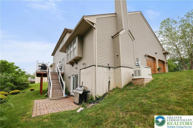 638 Stratton Dr, Middle Smithfield Twp, PA 18302 - view of property exterior with a yard, stairway, a chimney, and a deck