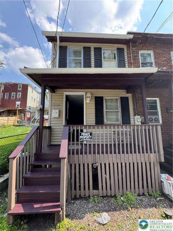 226 E Snyder Ave, Lansford Boro, PA 18232 - view of front facade featuring covered porch and brick siding
