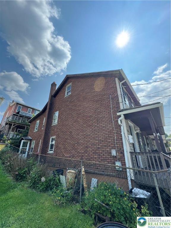226 E Snyder Ave, Lansford Boro, PA 18232 - view of side of home with brick siding and a chimney