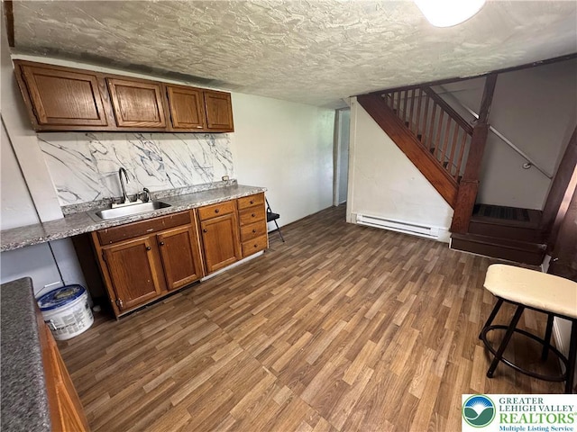 226 E Snyder Ave, Lansford Boro, PA 18232 - bar area with a baseboard heating unit, dark wood-style flooring, stairs, and backsplash