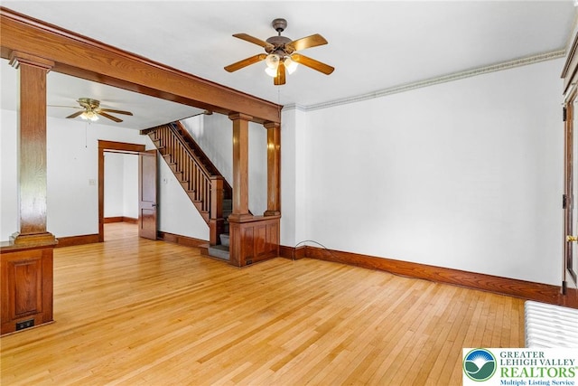 100 E Mahoning Dr, Mahoning Twp, PA 18235 - empty room featuring ceiling fan, light wood finished floors, decorative columns, and stairway