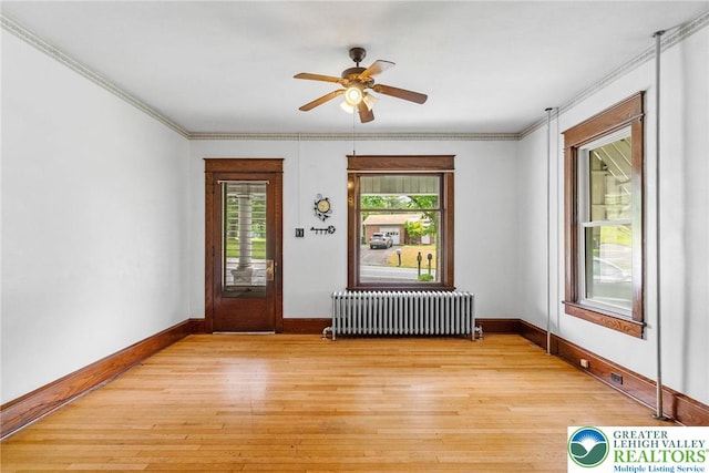 100 E Mahoning Dr, Mahoning Twp, PA 18235 - unfurnished room featuring radiator heating unit, ceiling fan, light wood-style flooring, and crown molding