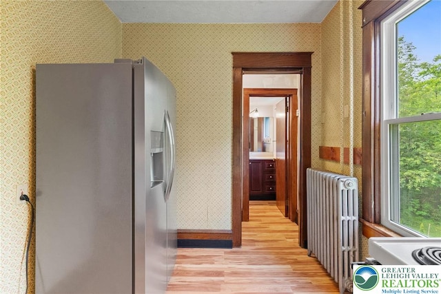 100 E Mahoning Dr, Mahoning Twp, PA 18235 - kitchen with stainless steel fridge with ice dispenser, radiator, light wood finished floors, wallpapered walls, and healthy amount of natural light