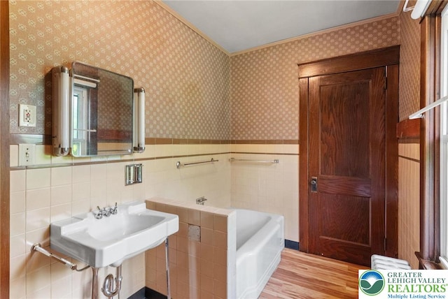 100 E Mahoning Dr, Mahoning Twp, PA 18235 - full bathroom featuring wood finished floors, a bath, wallpapered walls, wainscoting, and crown molding