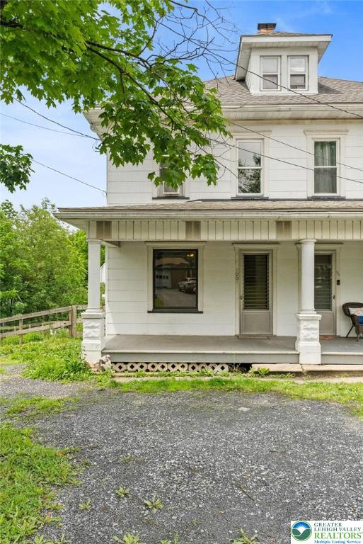 100 E Mahoning Dr, Mahoning Twp, PA 18235 - traditional style home featuring a porch, a shingled roof, and a chimney