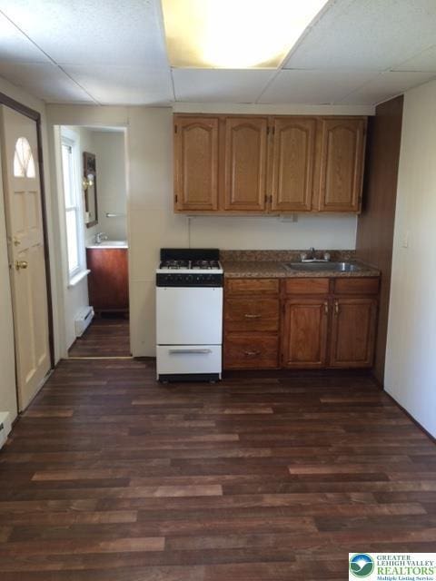 526 W Gordon St Unit 1, Allentown City, PA 18102 - kitchen featuring white range with gas stovetop, dark wood-style floors, dark countertops, and brown cabinetry