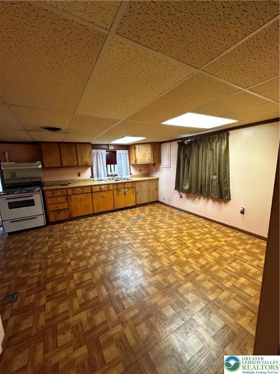 701 N Lacrosse St, Allentown City, PA 18109 - kitchen with range with gas cooktop, a drop ceiling, and brown cabinets