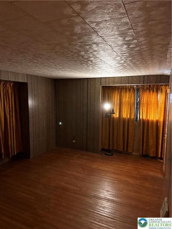 701 N Lacrosse St, Allentown City, PA 18109 - spare room with hardwood / wood-style flooring and wooden walls