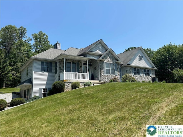 1437 Nectarine Rd, Lehigh Twp, PA 18038 - view of front of home featuring stone siding, covered porch, a front lawn, and a chimney