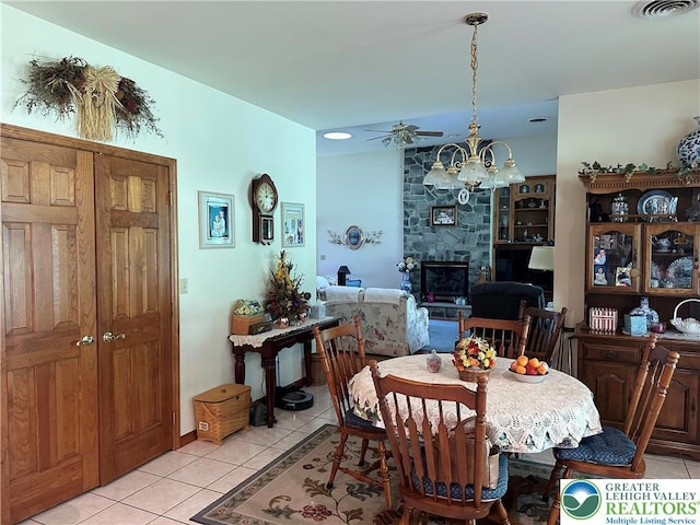 1437 Nectarine Rd, Lehigh Twp, PA 18038 - dining area featuring light tile patterned floors, a chandelier, and a stone fireplace