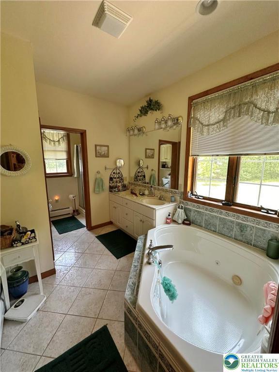 1437 Nectarine Rd, Lehigh Twp, PA 18038 - bathroom with a jetted tub, vanity, a baseboard radiator, and tile patterned floors