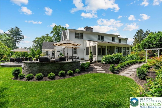 4704 Sweetbriar Cir, Lower Macungie Twp, PA 18049 - rear view of property featuring a patio, a chimney, a sunroom, and a yard