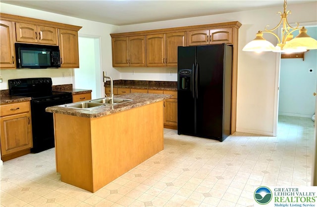 538 Carney Rd, Polk Twp, PA 18071 - kitchen with black appliances, dark countertops, an island with sink, brown cabinetry, and a chandelier