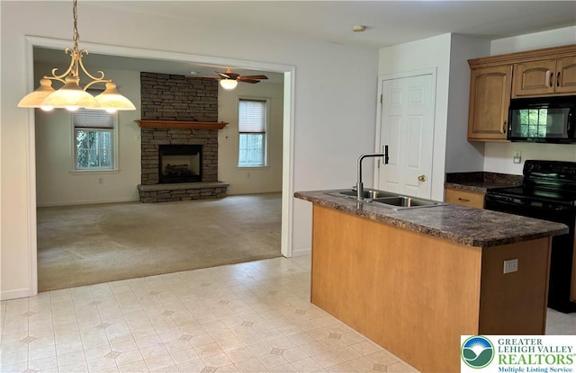 538 Carney Rd, Polk Twp, PA 18071 - kitchen featuring black appliances, light carpet, dark countertops, ceiling fan, and a stone fireplace