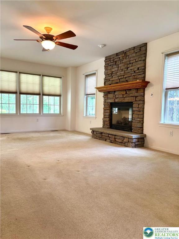 538 Carney Rd, Polk Twp, PA 18071 - unfurnished living room featuring plenty of natural light, a fireplace, a ceiling fan, and carpet