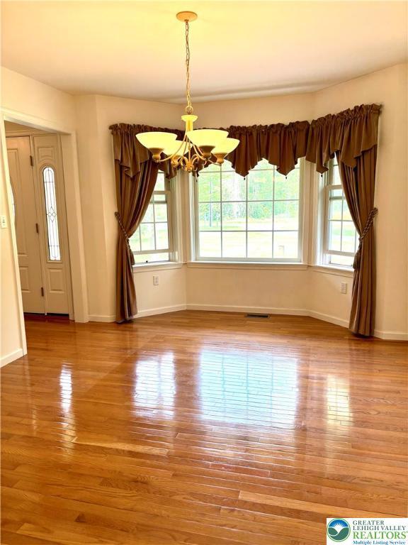 538 Carney Rd, Polk Twp, PA 18071 - unfurnished dining area with a chandelier and wood finished floors