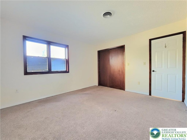 115 Foxfire Unit 306, Mount Pocono Boro, PA 18334 - unfurnished bedroom featuring carpet floors and a closet