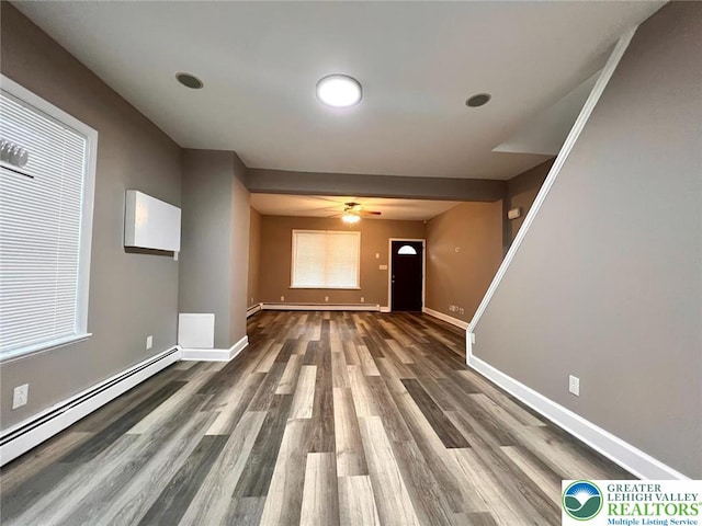820 Ridge St, West Easton Borough, PA 18042 - unfurnished living room featuring a baseboard heating unit, wood finished floors, and a ceiling fan