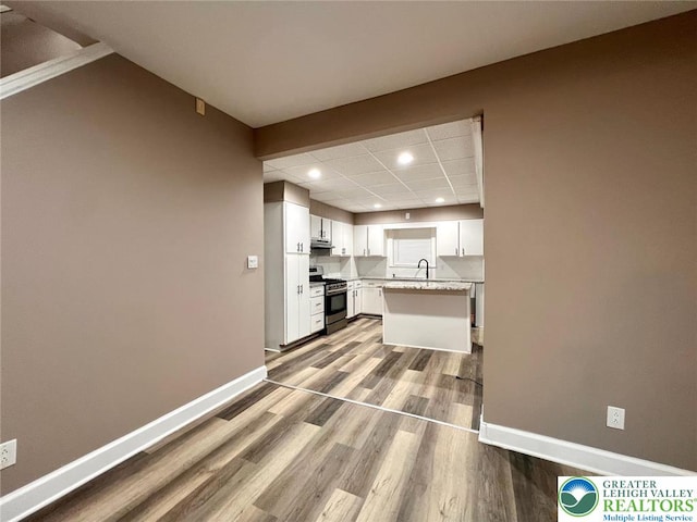820 Ridge St, West Easton Borough, PA 18042 - kitchen featuring gas stove, recessed lighting, wood finished floors, white cabinetry, and light countertops