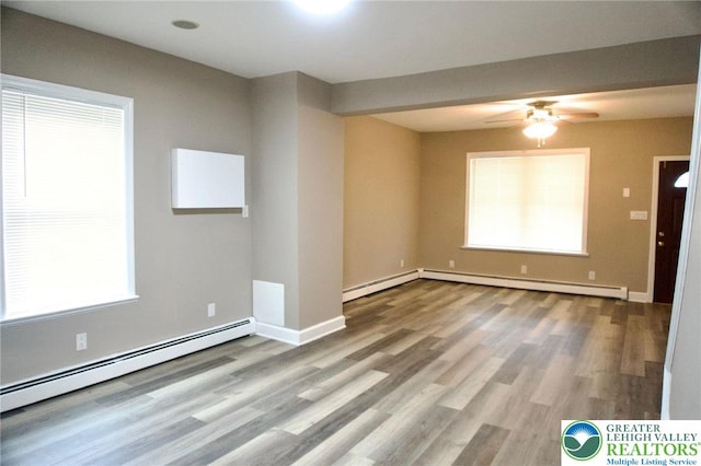 820 Ridge St, West Easton Borough, PA 18042 - empty room featuring a baseboard heating unit, wood finished floors, and ceiling fan
