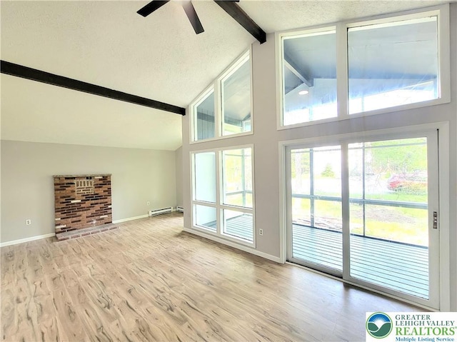 6522 Runnymead, Coolbaugh Twp, PA 18466 - unfurnished living room featuring beam ceiling, a ceiling fan, a baseboard heating unit, wood finished floors, and a textured ceiling