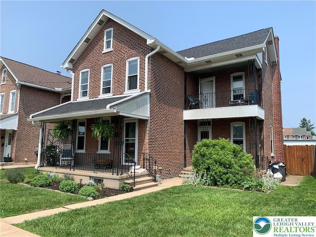 665 Walnut St, Emmaus Borough, PA 18049 - view of front facade with a porch, brick siding, and a balcony