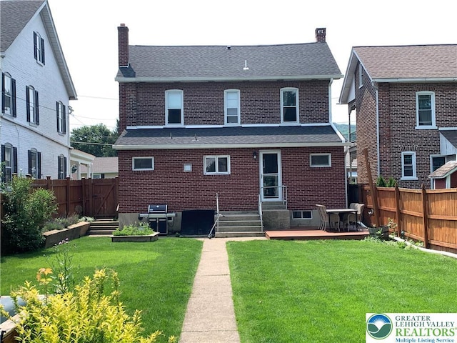 665 Walnut St, Emmaus Borough, PA 18049 - back of house with a chimney, a fenced backyard, brick siding, and a shingled roof