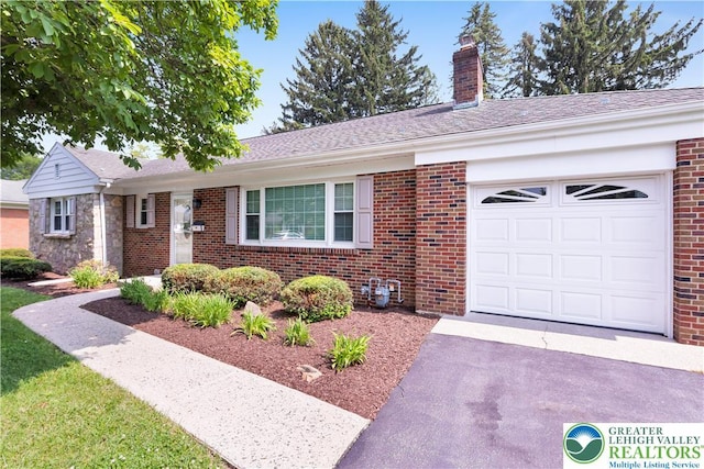 3032 W Woodlawn St, South Whitehall Twp, PA 18104 - ranch-style house featuring asphalt driveway, brick siding, a chimney, and a garage