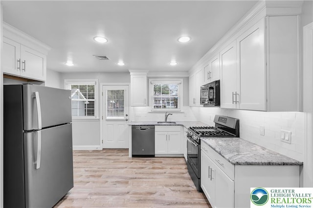 3032 W Woodlawn St, South Whitehall Twp, PA 18104 - kitchen with stainless steel appliances, white cabinetry, light stone counters, and recessed lighting