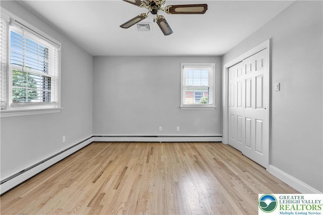 3032 W Woodlawn St, South Whitehall Twp, PA 18104 - unfurnished bedroom with baseboard heating, light wood-type flooring, a closet, and a ceiling fan