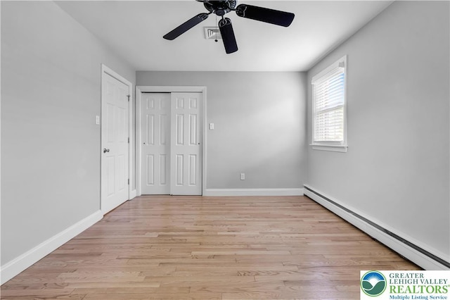 3032 W Woodlawn St, South Whitehall Twp, PA 18104 - unfurnished bedroom featuring baseboard heating, light wood-type flooring, a closet, and ceiling fan