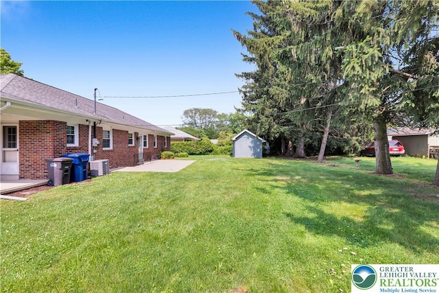 3032 W Woodlawn St, South Whitehall Twp, PA 18104 - view of green lawn with a patio and a storage unit