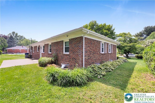 3032 W Woodlawn St, South Whitehall Twp, PA 18104 - view of property exterior with a yard, brick siding, and a patio area