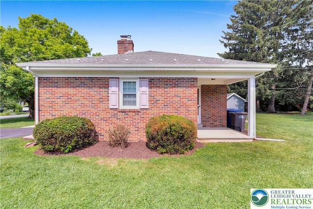 3032 W Woodlawn St, South Whitehall Twp, PA 18104 - view of property exterior featuring a chimney, a yard, and brick siding
