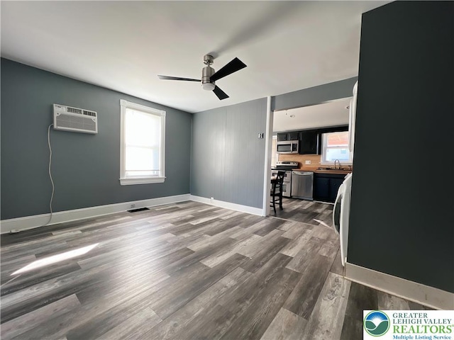 2236 2nd St, Easton, PA 18042 - spare room with an AC wall unit, ceiling fan, dark wood-type flooring, and washer / dryer