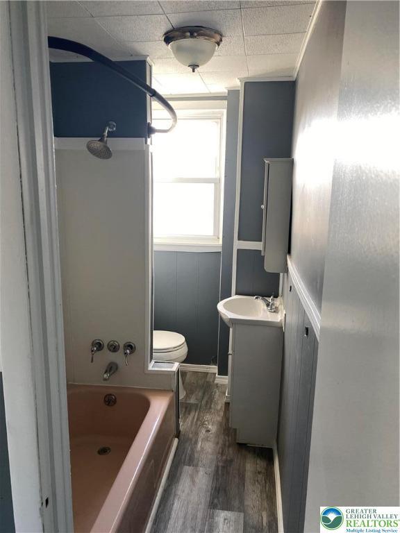 2236 2nd St, Easton, PA 18042 - full bath featuring vanity, wood finished floors,  shower combination, and a wainscoted wall