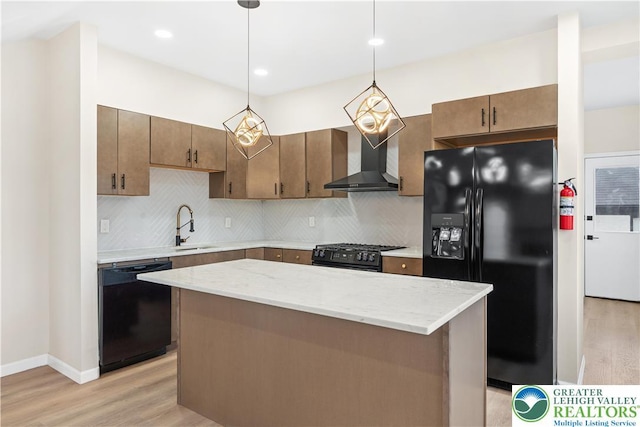 616 Highland Ave, Bethlehem City, PA 18018 - kitchen with black appliances, wall chimney range hood, light wood finished floors, backsplash, and recessed lighting