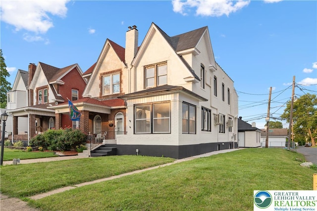 616 Highland Ave, Bethlehem City, PA 18018 - view of front of home featuring a front lawn, a chimney, and brick siding