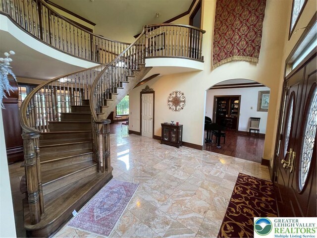 459 Mount Pleasant Rd, Washington Twp, PA 18013 - foyer entrance with arched walkways, a towering ceiling, stairs, and marble finish flooring