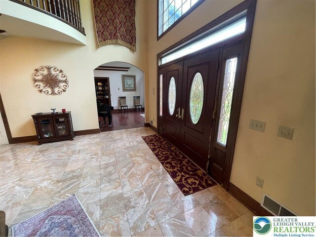 459 Mount Pleasant Rd, Washington Twp, PA 18013 - foyer entrance featuring arched walkways, a towering ceiling, and stone finish flooring