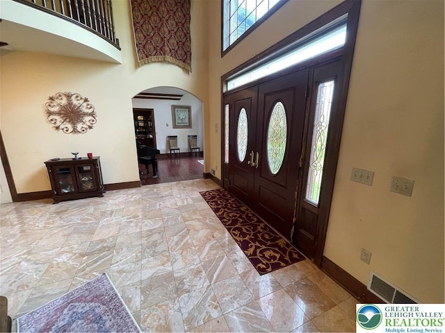 459 Mount Pleasant Rd, Washington Twp, PA 18013 - foyer entrance with arched walkways, a towering ceiling, and stone finish floors