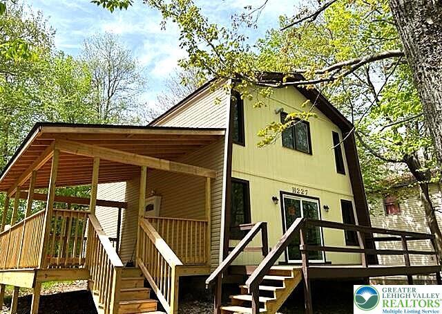 8237 Natures Dr, Coolbaugh Twp, PA 18466 - rear view of house featuring stairs and a deck