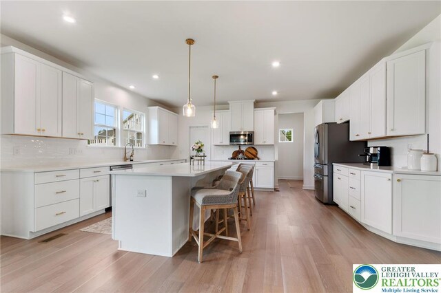 1615 Watson Loop, Upper Macungie Twp, PA 18051 - kitchen featuring stainless steel appliances, a breakfast bar area, a kitchen island, white cabinets, and recessed lighting